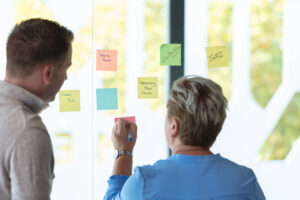 post-its op een glazen wand door een team